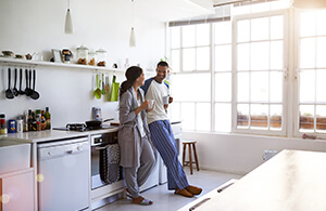 Couple standing in kitchen