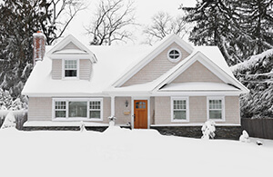 House and front yard covered in snow