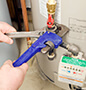 Fixing hot water heater with wrench